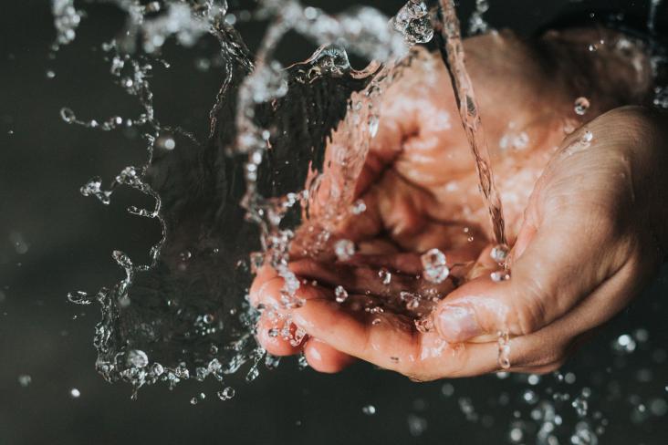 Hands under water tap