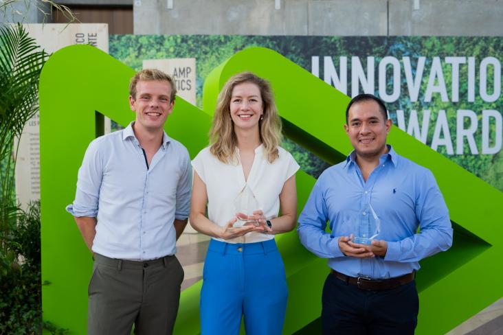 RELX Environmental Challenge winners standing in front of Pollutec logo with trophies